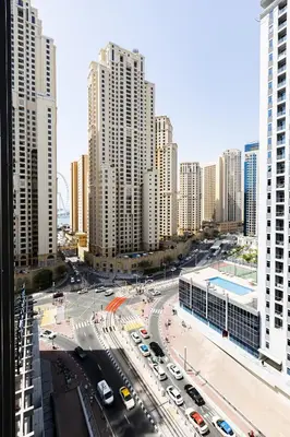 a city with a lot of traffic and tall buildings at Stunning 1BR with Breathtaking Views Dubai Marina in Dubai