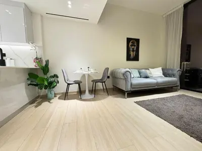 a living room with a couch and a table at DVR 1BR Apartment Available in Binghatti Corner in Dubai