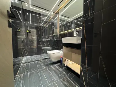 a bathroom with a white toilet and a sink at DVR 1BR Apartment Available in Binghatti Corner in Dubai
