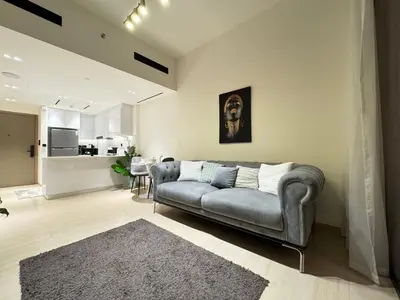 a living room with a couch and a table at DVR 1BR Apartment Available in Binghatti Corner in Dubai