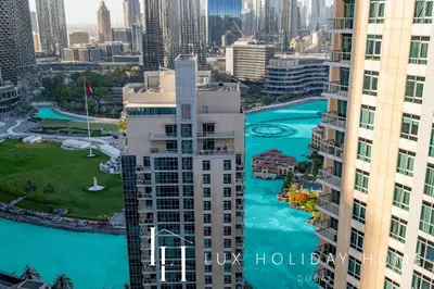 an aerial view of a city with a river and buildings at LUX The Burj Khalifa Fountain View Suite 3 in Dubai