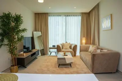 a living room with a couch and a table at Luxury 1BR Suite - Comfort Meets Class in Dubai