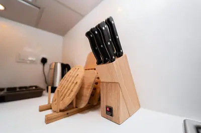 a wooden knife block sitting on top of a counter at Luxury 1BR Suite - Comfort Meets Class in Dubai