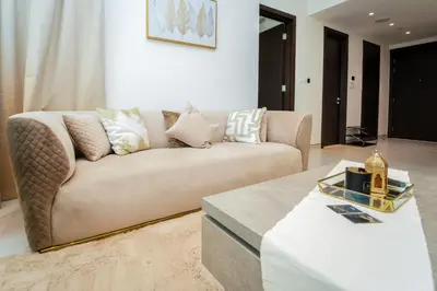 a living room with a couch and a table at Luxury 1BR Suite - Comfort Meets Class in Dubai