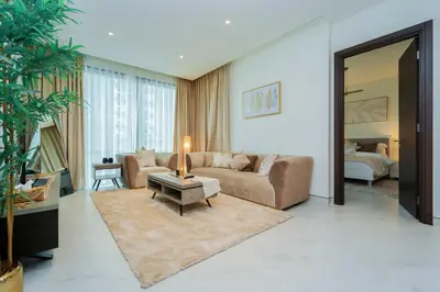 a living room with a couch and a table at Luxury 1BR Suite - Comfort Meets Class in Dubai