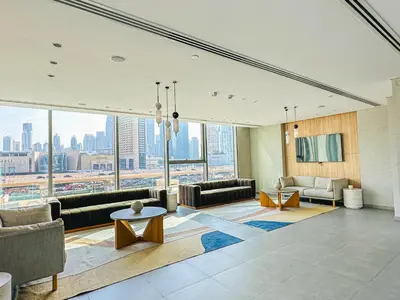 a living room with a view of a city at Luxurious 1BR High Floor Skyline View Downtown in Dubai
