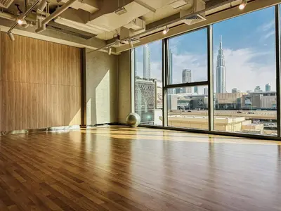 an empty room with a hardwood floor and large windows at Luxurious 1BR High Floor Skyline View Downtown in Dubai