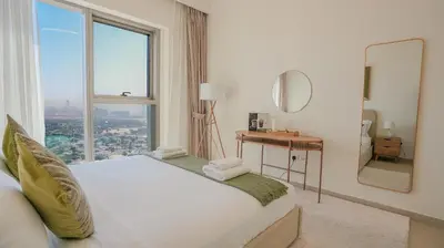 a bedroom with a bed with a large window at Luxurious 1BR High Floor Skyline View Downtown in Dubai