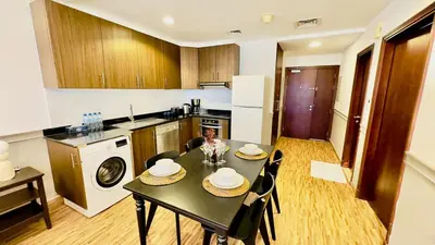 a kitchen with a black table and chairs in a room at Luxurious place to stay in Dubai Marina in Dubai