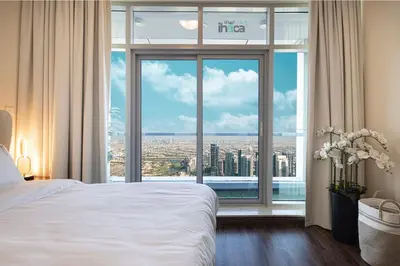 a hotel room with a bed and a large window at 71st Floor Luxury 1Br Spacious Skyline Balcony in Dubai
