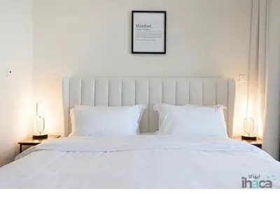 a white bed with white sheets and pillows at 71st Floor Luxury 1Br Spacious Skyline Balcony in Dubai