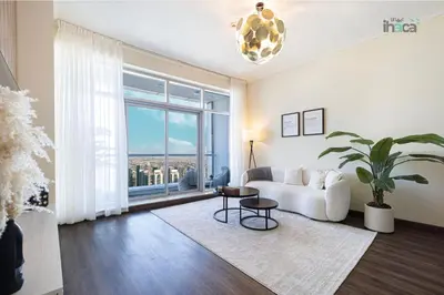 a living room with a couch and a large window at 71st Floor Luxury 1Br Spacious Skyline Balcony in Dubai
