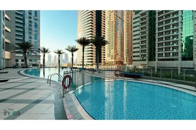 a large swimming pool in a city with tall buildings at 71st Floor Luxury 1Br Spacious Skyline Balcony in Dubai
