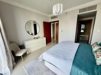 a bedroom with a large bed and a mirror at Elegant apartment Dubai downtown in Dubai