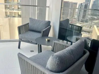 a room with chairs and tables and a view of a city at Elegant apartment Dubai downtown in Dubai
