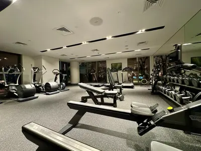 a gym with several treadmills and machines in it at Elegant apartment Dubai downtown in Dubai