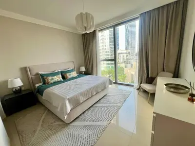 a bedroom with a bed and a large window at Elegant apartment Dubai downtown in Dubai