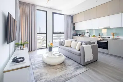 a living room with a couch and a table at Frank Porter - Noor 3 Midtown in Dubai