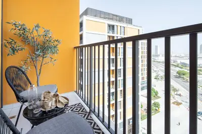 a balcony with a table and a view of a building at Frank Porter - Noor 3 Midtown in Dubai