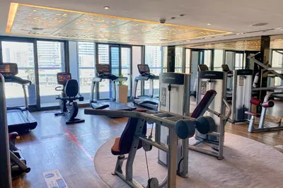 a gym with treadmills and exercise equipment in a building at ALiving Luxury 3BR High-Rise I Burj Khalifa View I Paramount Towers, 6101 in Dubai