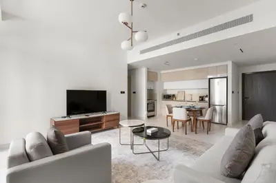 a living room with a white couch and a tv at Luxury Stay at Marina Vista, Dubai Harbour in Dubai