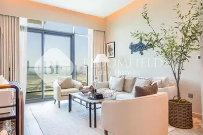 a living room with a couch and chairs and a table at Bloomfields 1br Azizi Farhad Burj View Bliss in Dubai