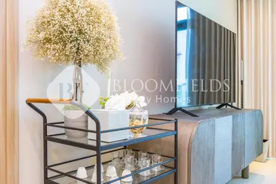 a glass shelf with a vase on top of it at Bloomfields 1br Azizi Farhad Burj View Bliss in Dubai