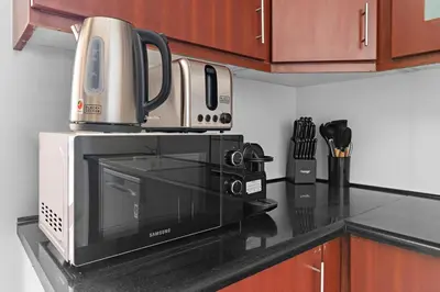 a microwave sitting on top of a kitchen counter at 2-Bedroom Apartment Near To The Beach in Sadaf in Dubai