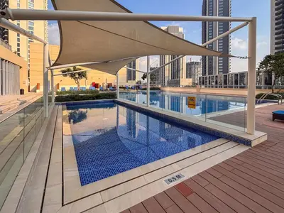 a swimming pool with an umbrella on top of a building at Frank Porter - Harbour Views T1 in Dubai