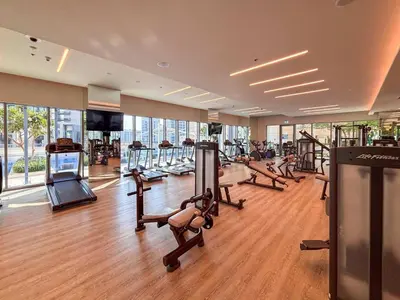 a gym with a bunch of treadmills and ellipticals at Frank Porter - Harbour Views T1 in Dubai