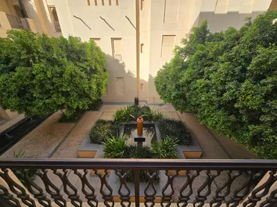 a view from a balcony of a building with a garden at EasyGo- Spacious, Authentic, City Center in Dubai