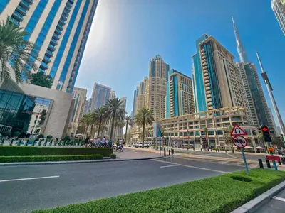 a street in a city with tall buildings at EasyGo- Spacious, Authentic, City Center in Dubai
