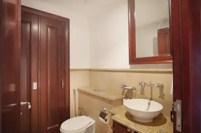 a bathroom with a toilet and a sink at EasyGo- Spacious, Authentic, City Center in Dubai
