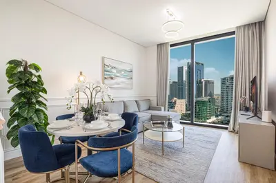 a living room with a couch and a table at Beachfront Bliss - Marina View - JBR The Address By ĀYA Boutique in Dubai