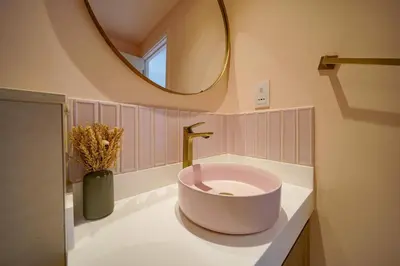 a bathroom with a bowl sink and a mirror at PVH - 2BR Artistic Retreat in Downtown Views 2 in Dubai