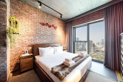 a bedroom with a bed and a brick wall at PVH - Edgy and Modern Comfort 1BR Downtown Views 2 in Dubai