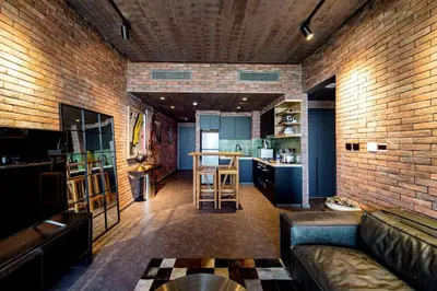 a living room with a couch and a brick wall at PVH - Edgy and Modern Comfort 1BR Downtown Views 2 in Dubai