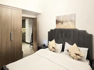 a bedroom with a large bed with white sheets and pillows at Azizi Riviera15 - Meydan by Golden Casa in Dubai