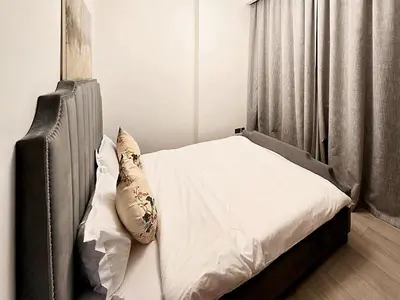 a bed with white sheets and pillows in a bedroom at Azizi Riviera15 - Meydan by Golden Casa in Dubai