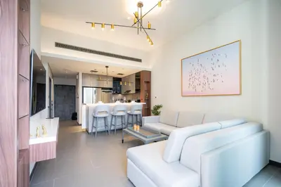 a living room with white furniture and a dining room at High Floor With Marina View in Dubai