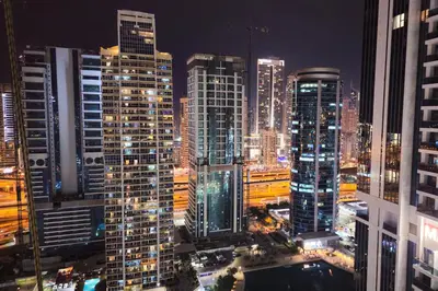a city skyline at night with many tall buildings at High Floor With Marina View in Dubai