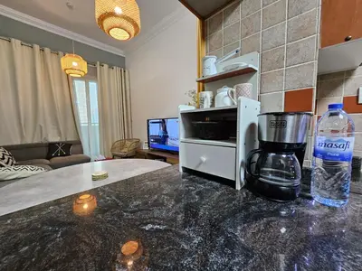 a kitchen with a coffee maker on a counter at Royal Residence - Dream tower Marina in Dubai
