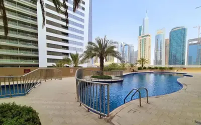 a swimming pool in a city with tall buildings at Royal Residence - Dream tower Marina in Dubai