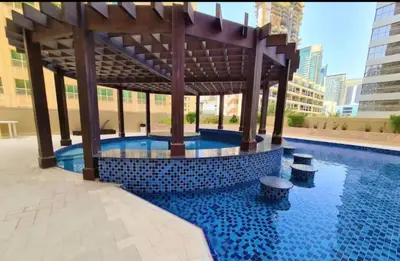a swimming pool with a gazebo in a city at Royal Residence - Dream tower Marina in Dubai