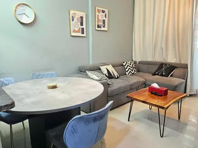 a living room with a couch and a table at Royal Residence - Dream tower Marina in Dubai