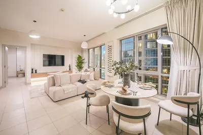 a living room with a couch and a table and chairs at EasyGo-Signature, City Center, City view in Dubai