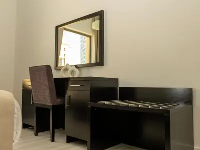 a bedroom with a desk and a mirror and a chair at 2Br Panoramic sea view, Ain Dubai, Palm, JBR beach in Dubai