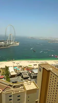 a view of a city with a ferris wheel and the beach at 2Br Panoramic sea view, Ain Dubai, Palm, JBR beach in Dubai