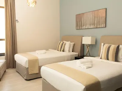 a bedroom with two beds and a lamp at 2Br Panoramic sea view, Ain Dubai, Palm, JBR beach in Dubai