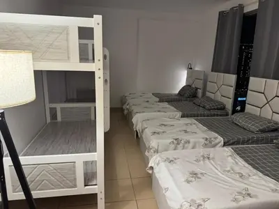a room with three bunk beds and a lamp at 50 Shades of stay in Dubai